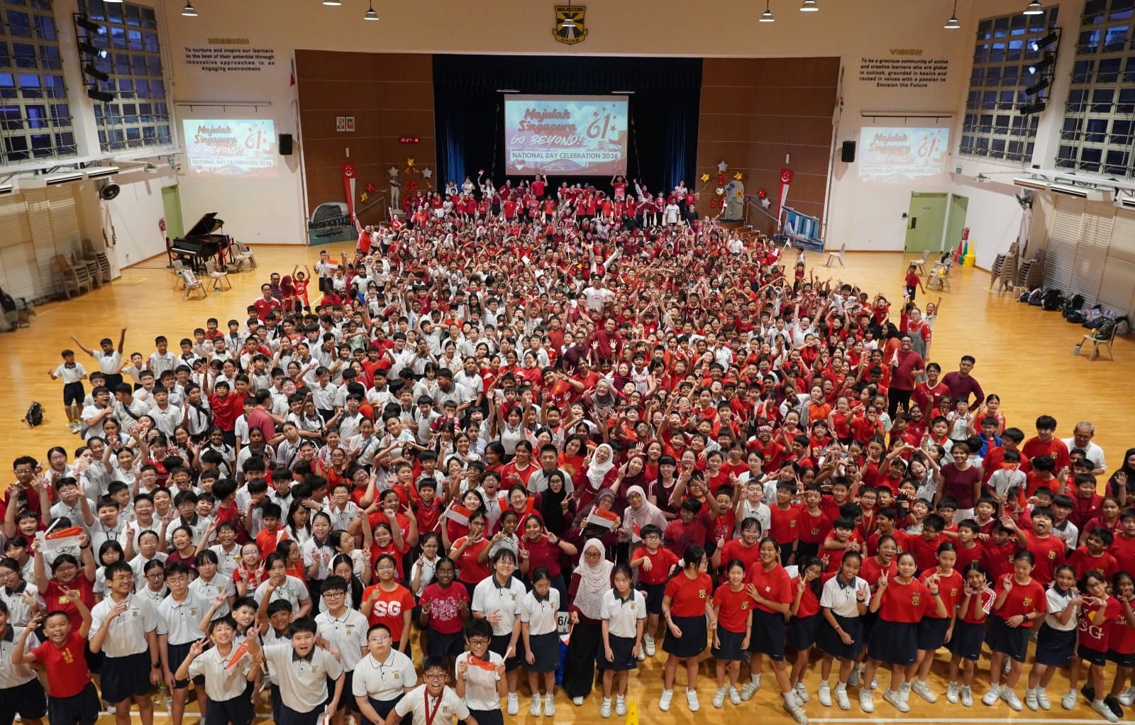 One Beacon Family: A beautiful snapshot of unity! The entire Beacon Primary School community—students and staff alike—gathers in red and white to mark this year's celebrations.